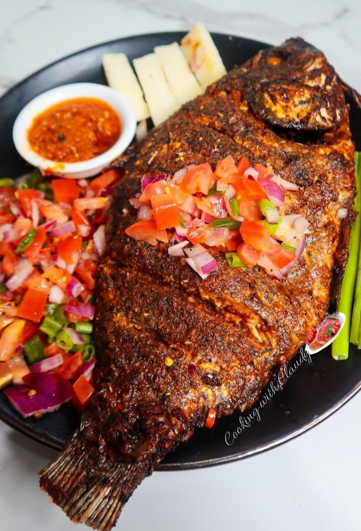 Grilled tilapia topped with fresh Kachumbari salad (tomatoes, onions, and chili)