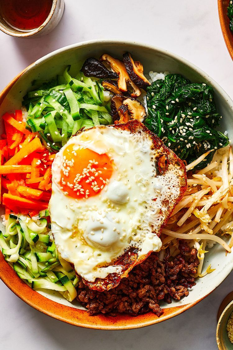 Bibimbap: colorful Korean rice bowl with vegetables, beef, and a fried egg on top